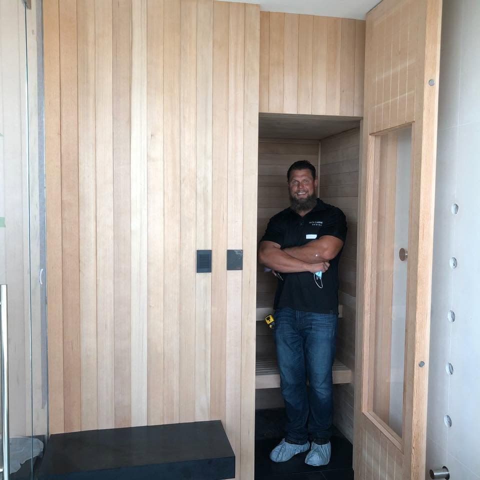 Andrey Voronenko on site in a custom wood-paneled build