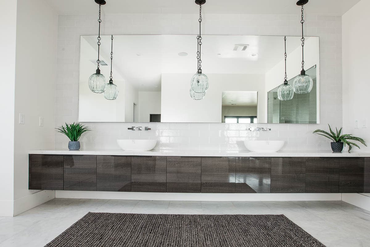 Slab-front floating vanity built by AV’s Cabinets